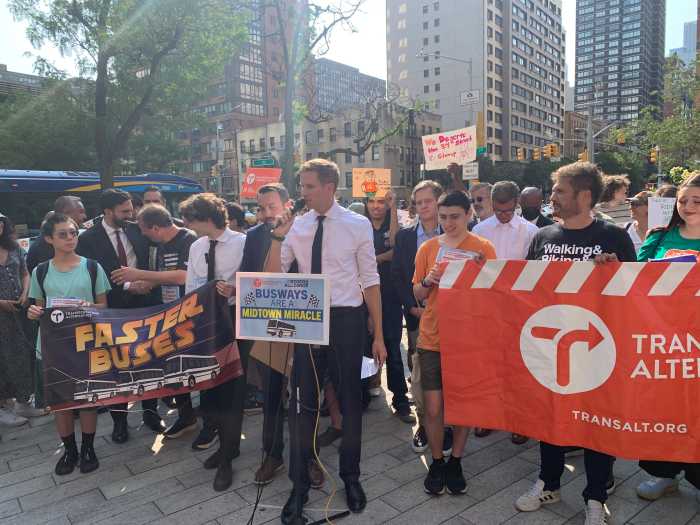 Victory on 34th Street: Transit groups, Manhattan pols leave bus in the dust in bustling Midtown 2 man in a white shirt at a podium surrounded by people