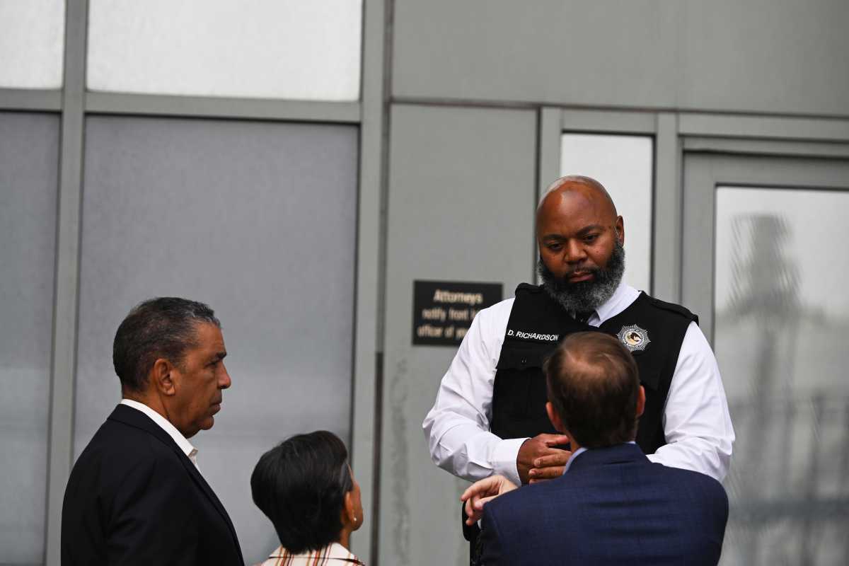 federal agent with ICE speaking with NYC Congress members at Brooklyn facility