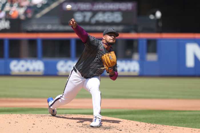 Frankie Montas Mets Giants: Baseball player in grey uniform and white pants throws ball off mound