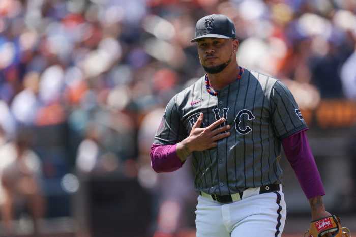 Frankie Montas Mets: Man in grey baseball uniform walks off field with hand on chest.