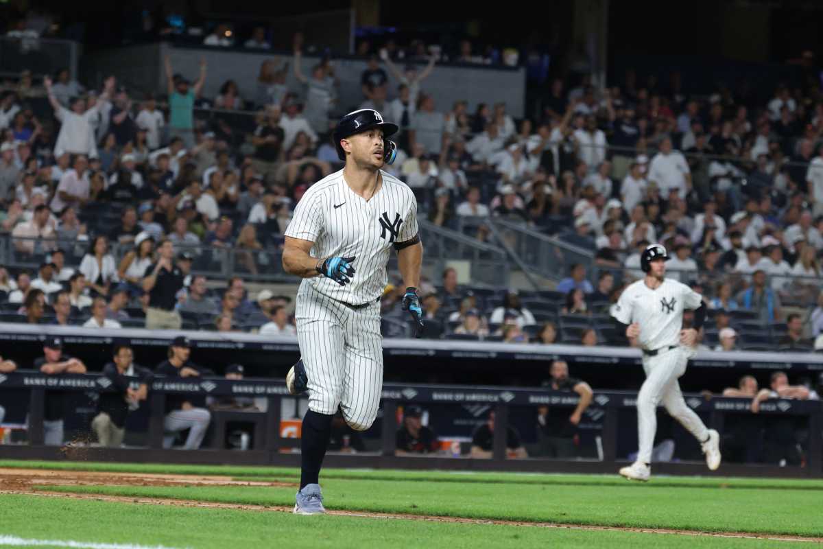 Giancarlo Stanton Yankees home run Twins: Man in pinstriped uniform runs toward first base after hitting home run