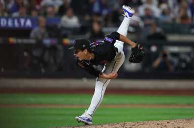 Jonah Tong of Mets throws funky off pitching mound.