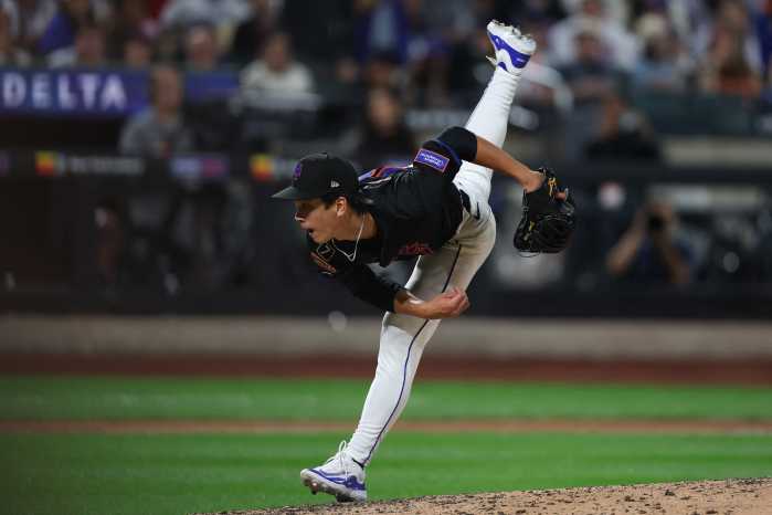 Jonah Tong of Mets throws funky off pitching mound.
