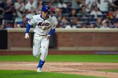 Mark Vientos double Mets Phillies: Man in wihte uniform runs to first base after hitting ball