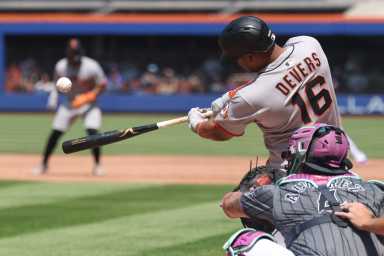 Rafael Devers Giants Mets: Baseball player in grey uniform and black helmet connects for home run