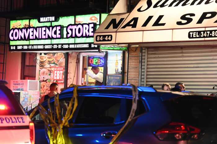 a storefront with police in front in Queens