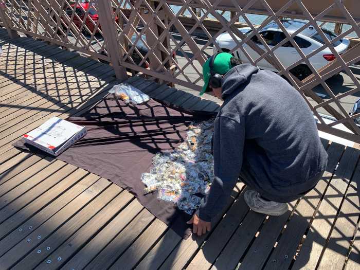 man spreading out keychains on a blanket