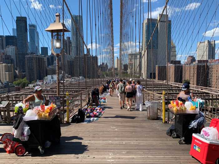 people walking on the Brooklyn Bridge during the day