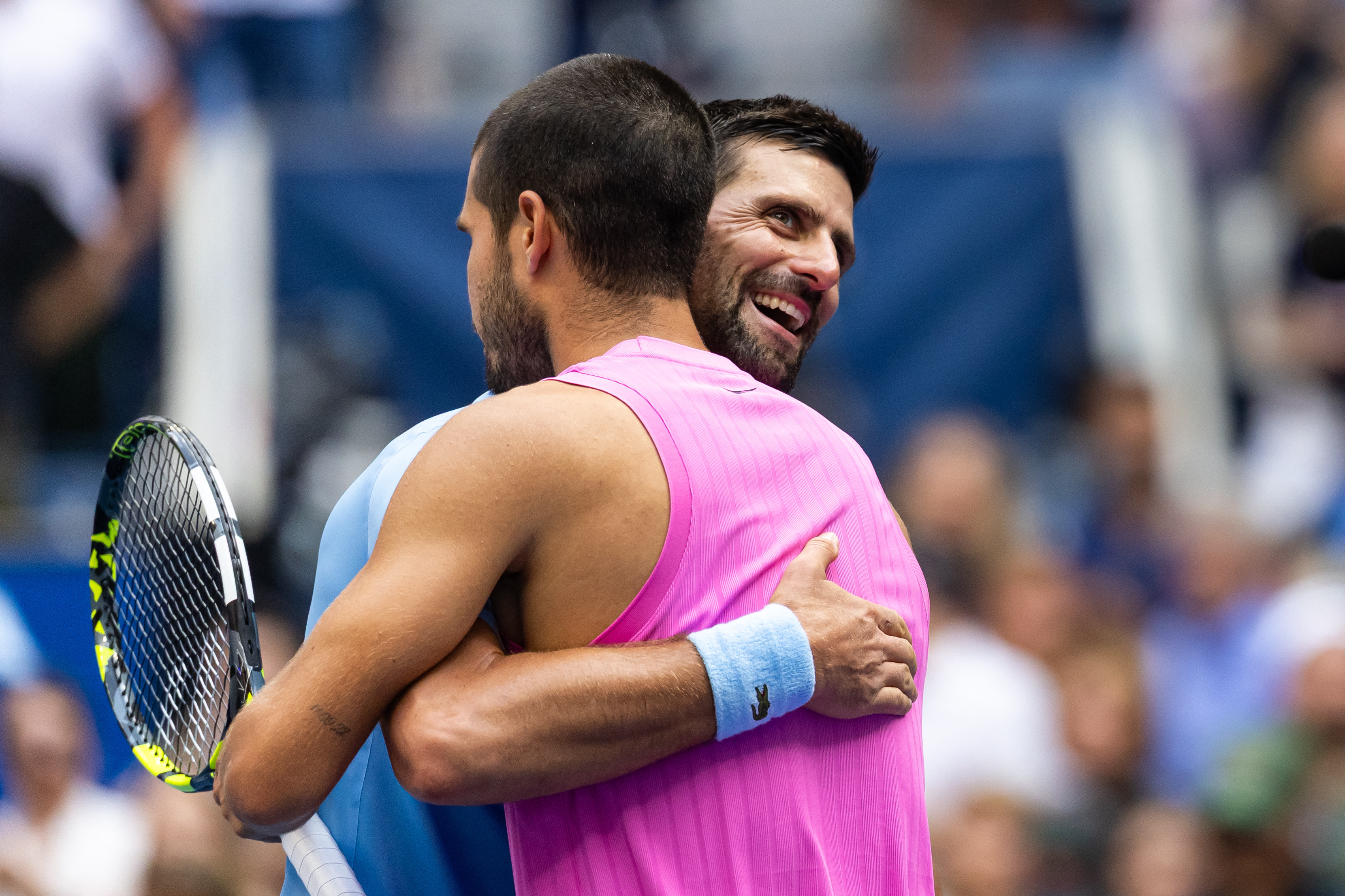 Alcaraz races past Djokovic to book US Open final spot 2 Sep 5, 2025; Flushing, NY, USA; Carlos Alcaraz of Spain and Novak Djokovic of Serbia embraces after their match in the semifinal of the mens singles at the US Open at Arthur Ashe Stadium in Billie Jean King National Tennis Center. Mandatory Credit: Mike Frey-Imagn Images
