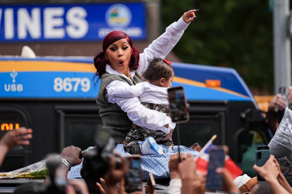 Cardi B celebrating with baby near MTA bus