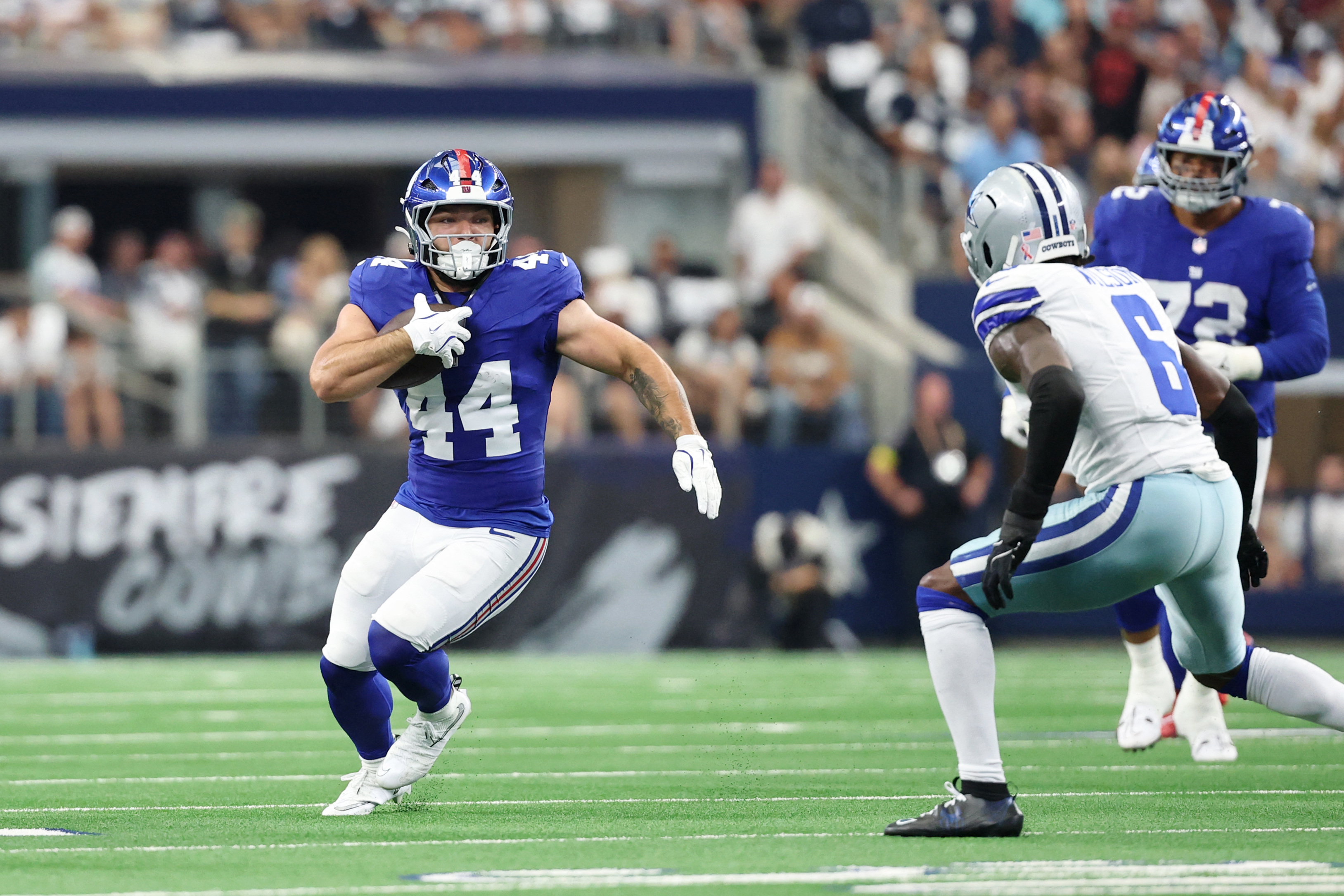 Giants vs. Chargers Week 4 preview: Jaxson Dart to start, what to watch, more 3 Cam Skattebo: Man in blue football uniform runs with football toward defender in white uniform