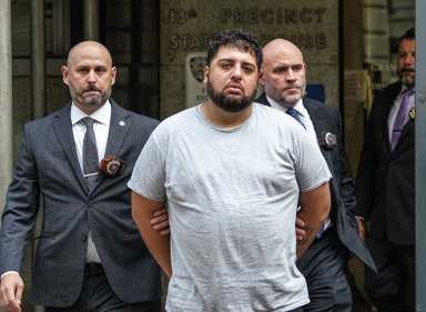 suspect in Midtown shooting near mexican day parade escorted by detectives handcuffed