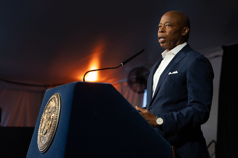Mayor Eric Adams speaking at podium