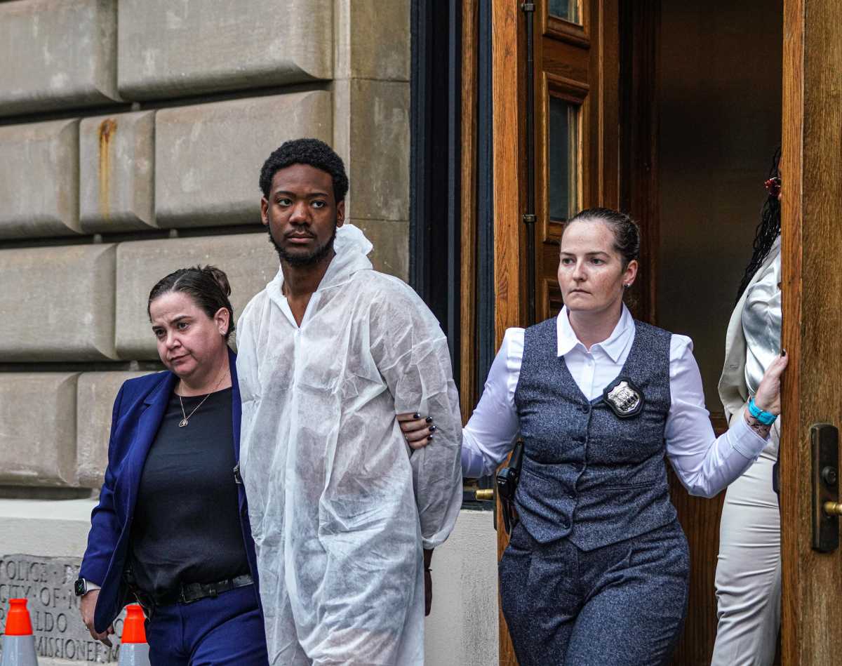 suspect in Bronx rape case handcuffed while wearing a Tyvek suit