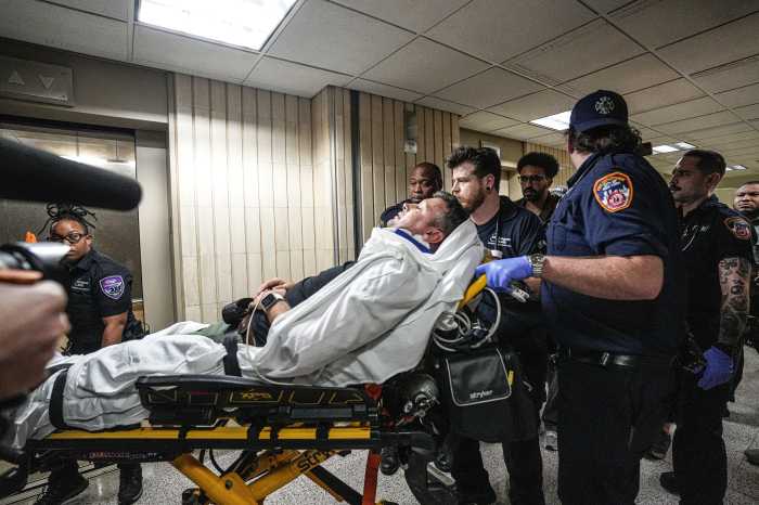 EMS members tend to injured journalist L. Vural Elibol after an ICE agent apparently shoved him hard to the floor at 26 Federal Plaza in Lower Manhattan on Sept. 30, 2025.