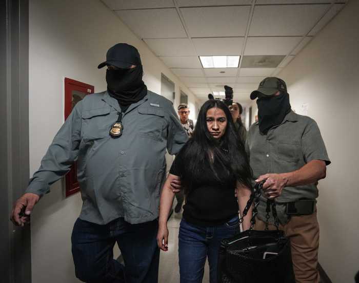 A woman is pulled away by ICE at 26 Federal Plaza in Lower Manhattan on Sept. 3, 2025.