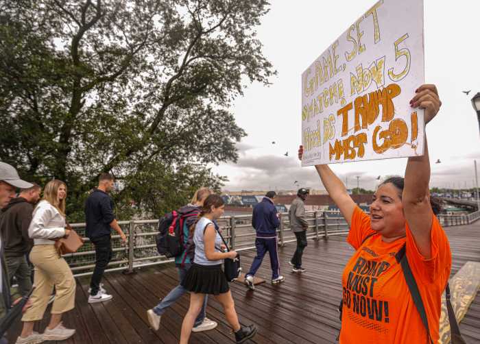 Protester against Trump stands outside US Open final during president's appearance.