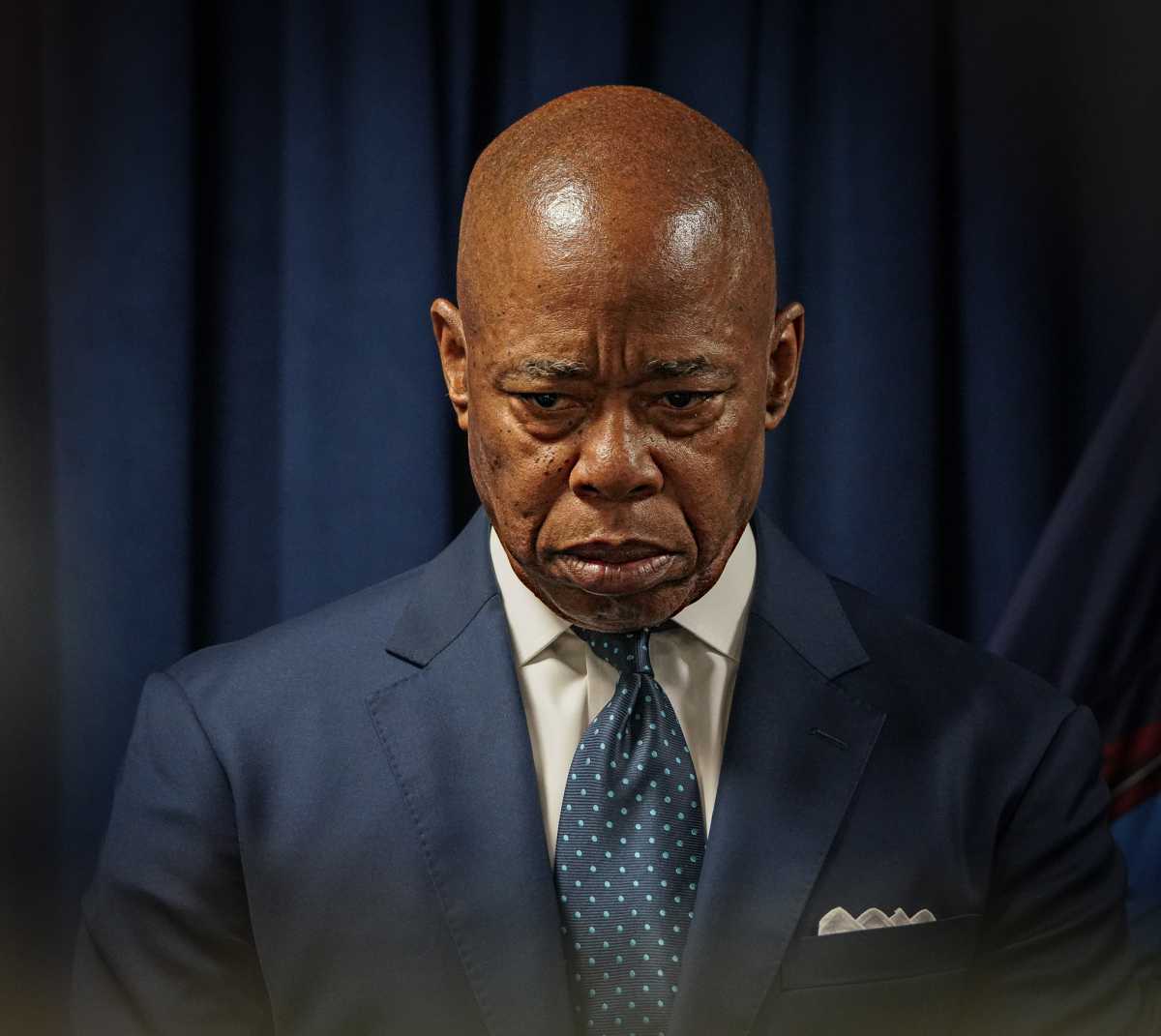 Mayor Eric Adams with his head down