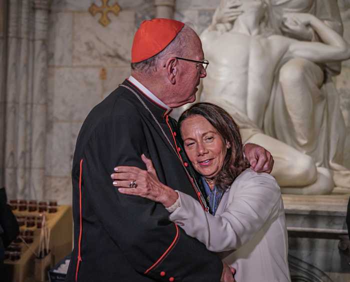 Cardinal Dolan embraces woman at Stand Up Sunday Mass against antisemitism