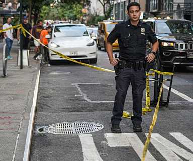 Police at crime scene near Mexican Day Parade in Midtown