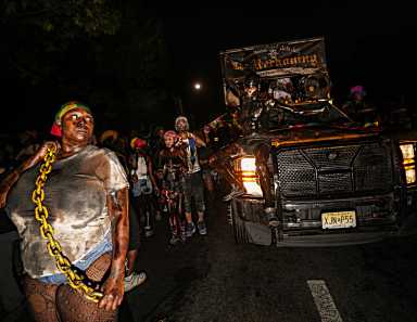 People dancing in the streets during J'Ouvert celebration in Brooklyn