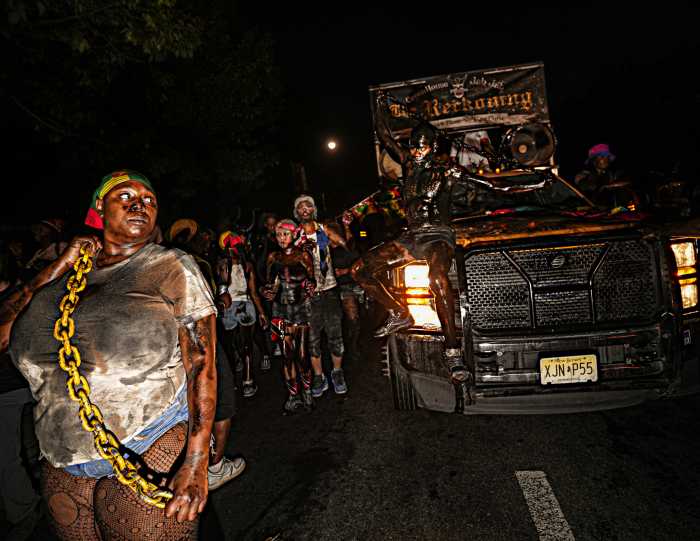 People dancing in the streets during J'Ouvert celebration in Brooklyn