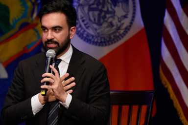 zohran mamdani man with beard speaking into microphone