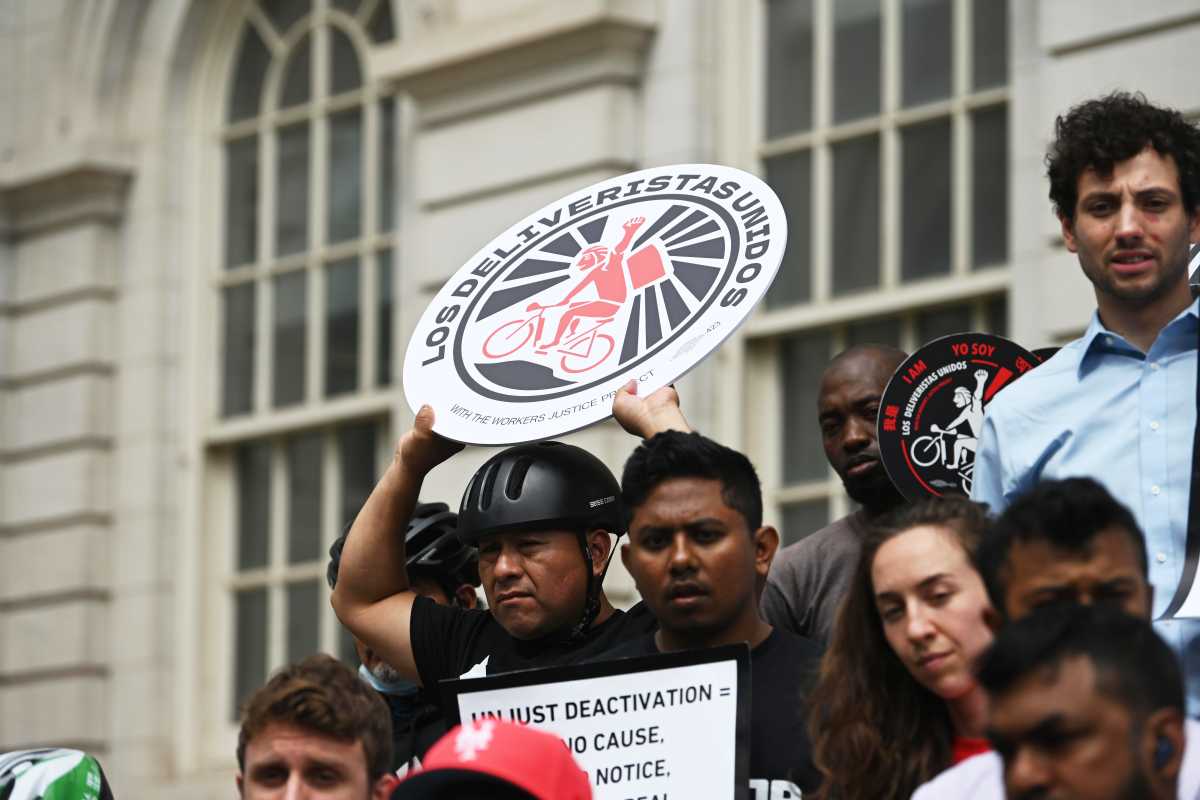 Deliveristas rallied at City Hall for protections from being fired without cause from delivery apps.
