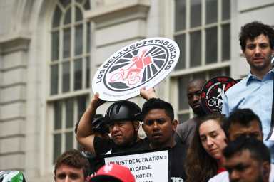 Deliveristas rallied at City Hall for protections from being fired without cause from delivery apps.