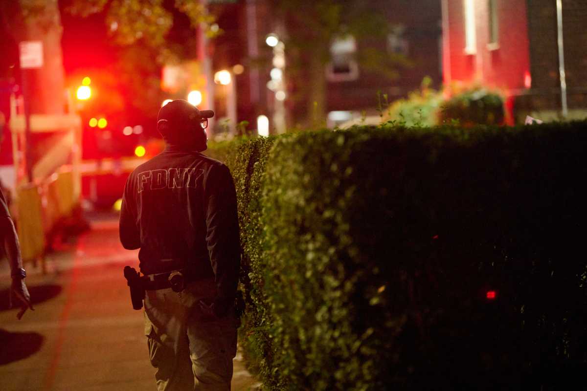 firefighter in Brooklyn looks up at scene where man was found dead