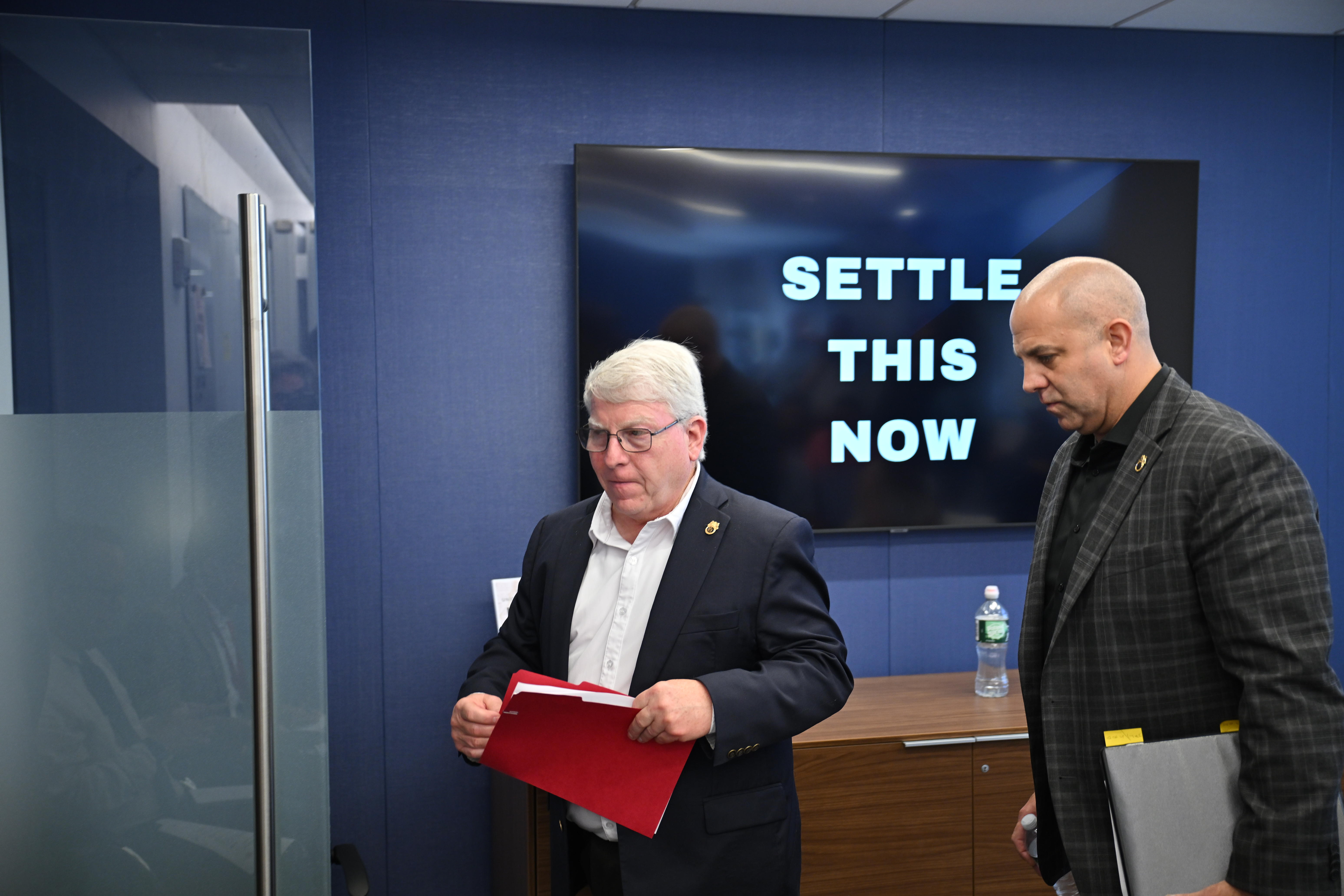 James Louis and Kevin Sexton leave the press conference.