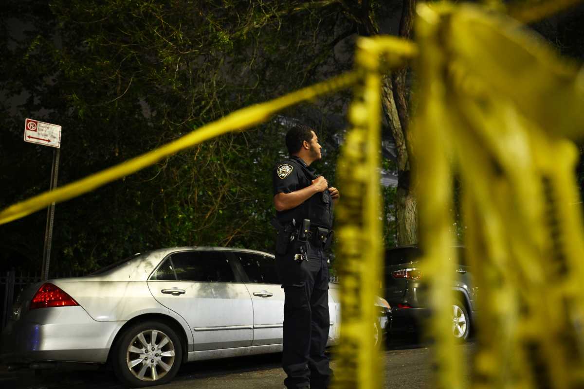 nypd at the scene in front of crime scene tape in Brooklyn