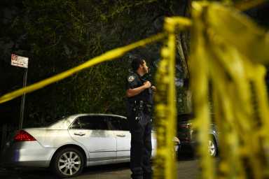 nypd at the scene in front of crime scene tape in Brooklyn