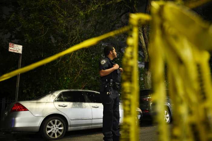 nypd at the scene in front of crime scene tape in Brooklyn
