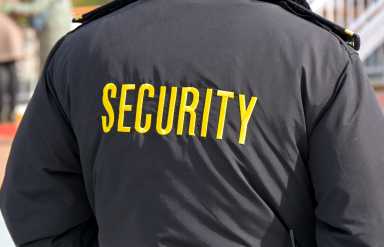 Embroidered word Security on the back of a uniform jacket