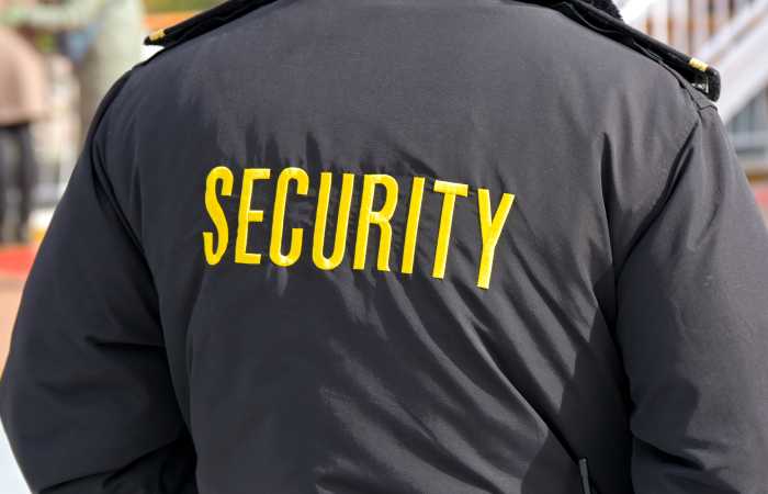 Embroidered word Security on the back of a uniform jacket