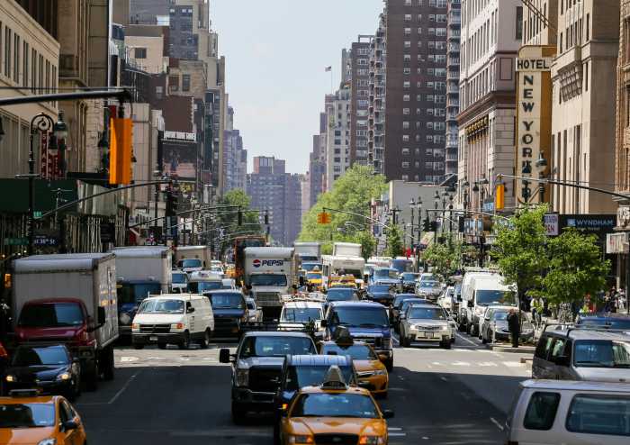 Many cars driving through the jammed streets of new york