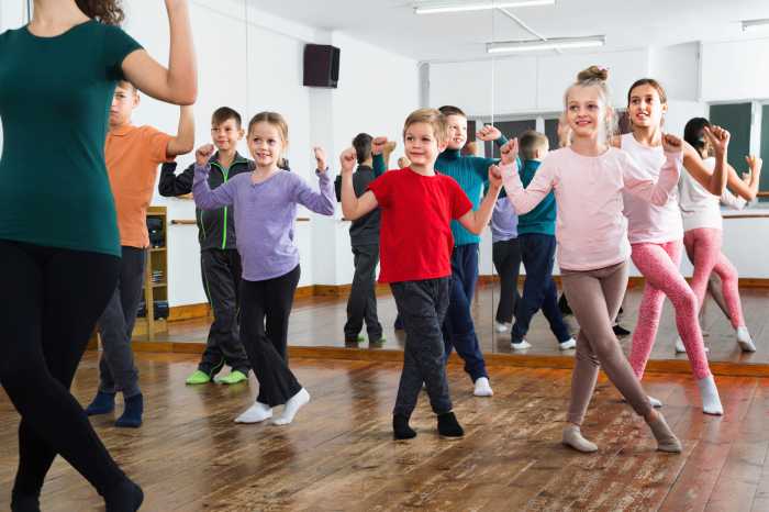 Friendly children dancing contemp in studio smiling and having fun