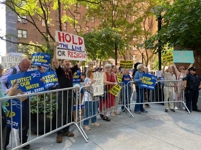 Protestors rally outside Sen. Schumer's Midtown office urging he 'hold the line or resign' against GOP spending cuts 2 Protesters gathered outside Senator Chuck Schumer’s Midtown office, urging him to 'hold the line' against GOP spending cuts