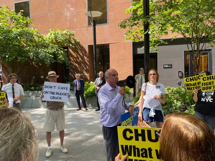 Protestors rally outside Sen. Schumer's Midtown office urging he 'hold the line or resign' against GOP spending cuts 3 Eric Weltman, senior New York organizer at Food & Water Watch, addresses protesters outside Senator Schumer’s Midtown office after a meeting with his staffers