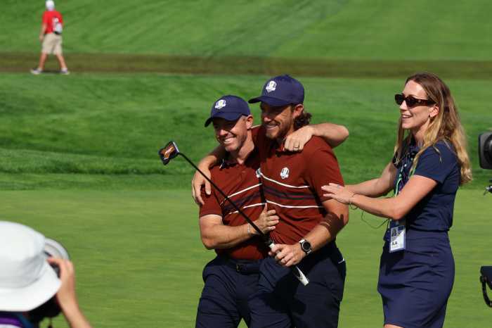 Rory McIlroy and Tommy Fleetwood celebrate after sealing a 3&2 victory over Harris English and Collin Morikawa in Saturday morning's Ryder Cup foursomes at Bethpage Black. Photo: Dylan Christie/amNew York.