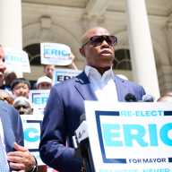 Why is Eric Adams staying in the mayor's race despite low polls? Experts offer a few possible reasons 6 Mayor Eric Adams wearing sunglasses while standing in front of podium