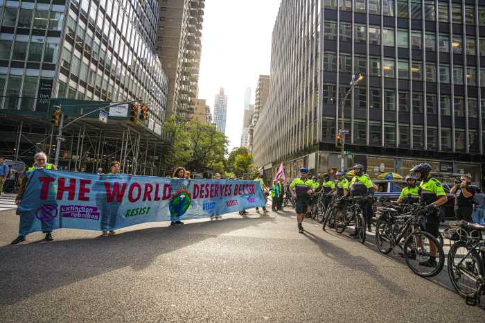 Protesters unfurl banner against drilling at protest during UN General Assembly
