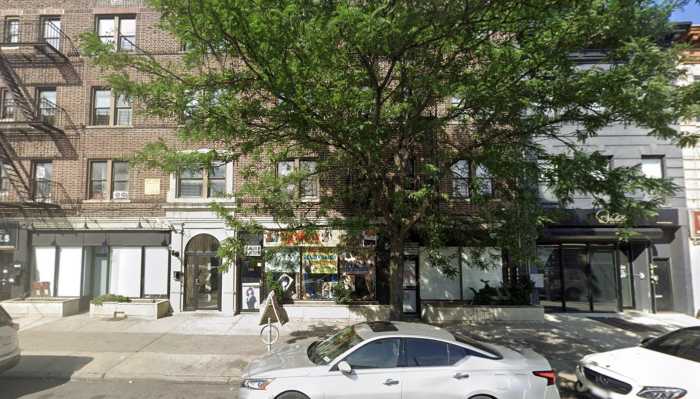 The apartment building at 1789 Flatbush Ave. in Brooklyn, where police say a 66-year-old maintenance worker was beaten on Sept. 19. Investigators said one of the attackers struck the man with a plastic A-frame sign taken from a nearby beauty salon, visible on the right.