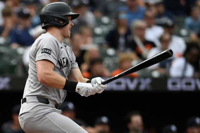Ben Rice Yaknees Orioles: Man in grey uniform follows through on single with bat in hands.