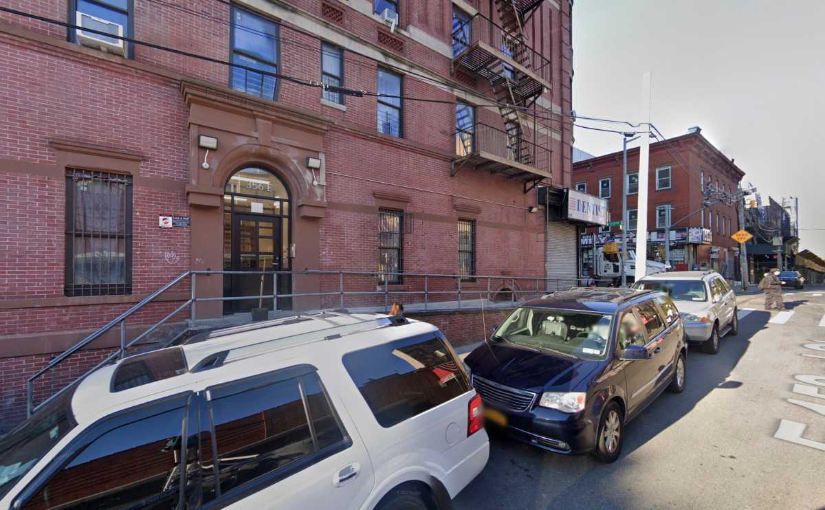 apartment building in Bronx where shooting occurred with cars parked out front