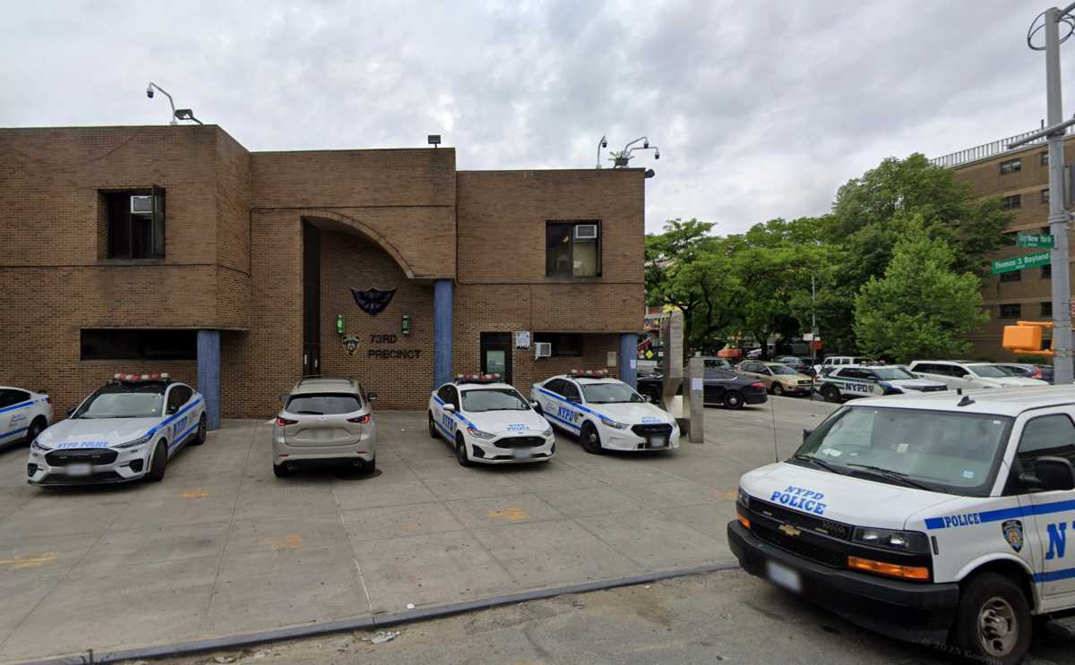 building with police vehicles in front of it in brooklyn