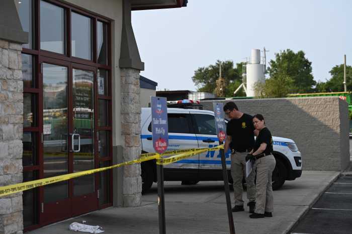 police investigators outside Brooklyn IHOP restaurant with crime scene tape