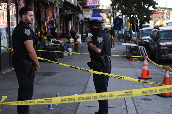 police officers and crime scene tape at scene of Brooklyn shooting