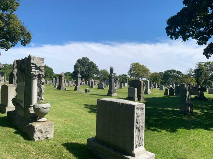 cemetery tombstones during the day in Queens' Middle Village area.